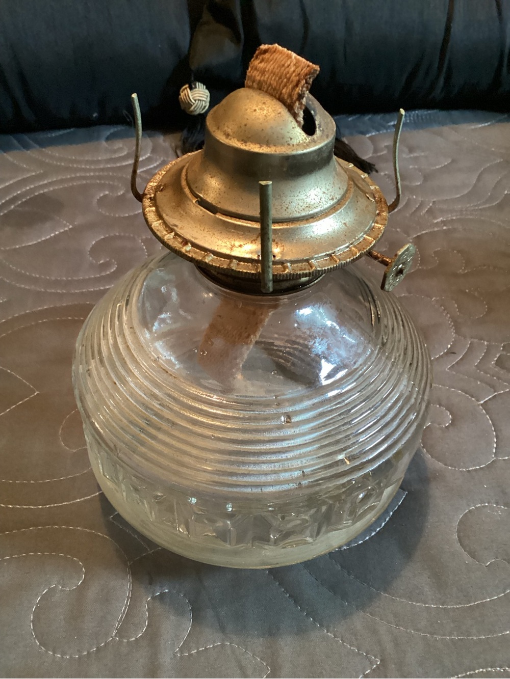 Vintage clear glass oil lamp featuring textured design,